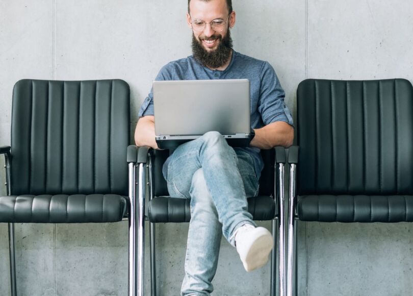 man-with-laptop-sitting-in-chair