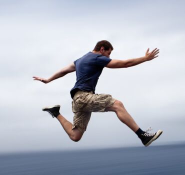 man-jumping-on-rocks man-jumping-on-rocks