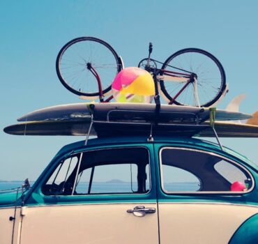 car-with-surfboards-and-bike-on-roof