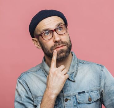 man-with-glasses-and-beanie-thinking