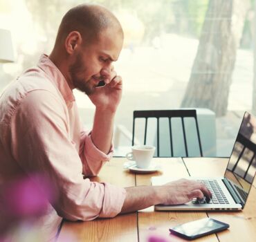 man-calling-behind-his-laptop man-calling-behind-his-laptop